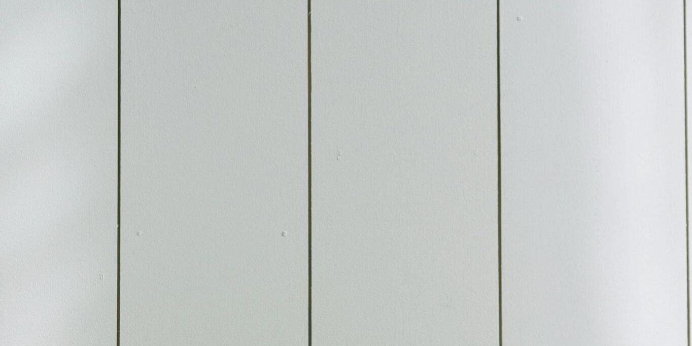 Photo by Ivan Samkov A sleek payment terminal with buttons against a white wooden background, ideal for finance concept.